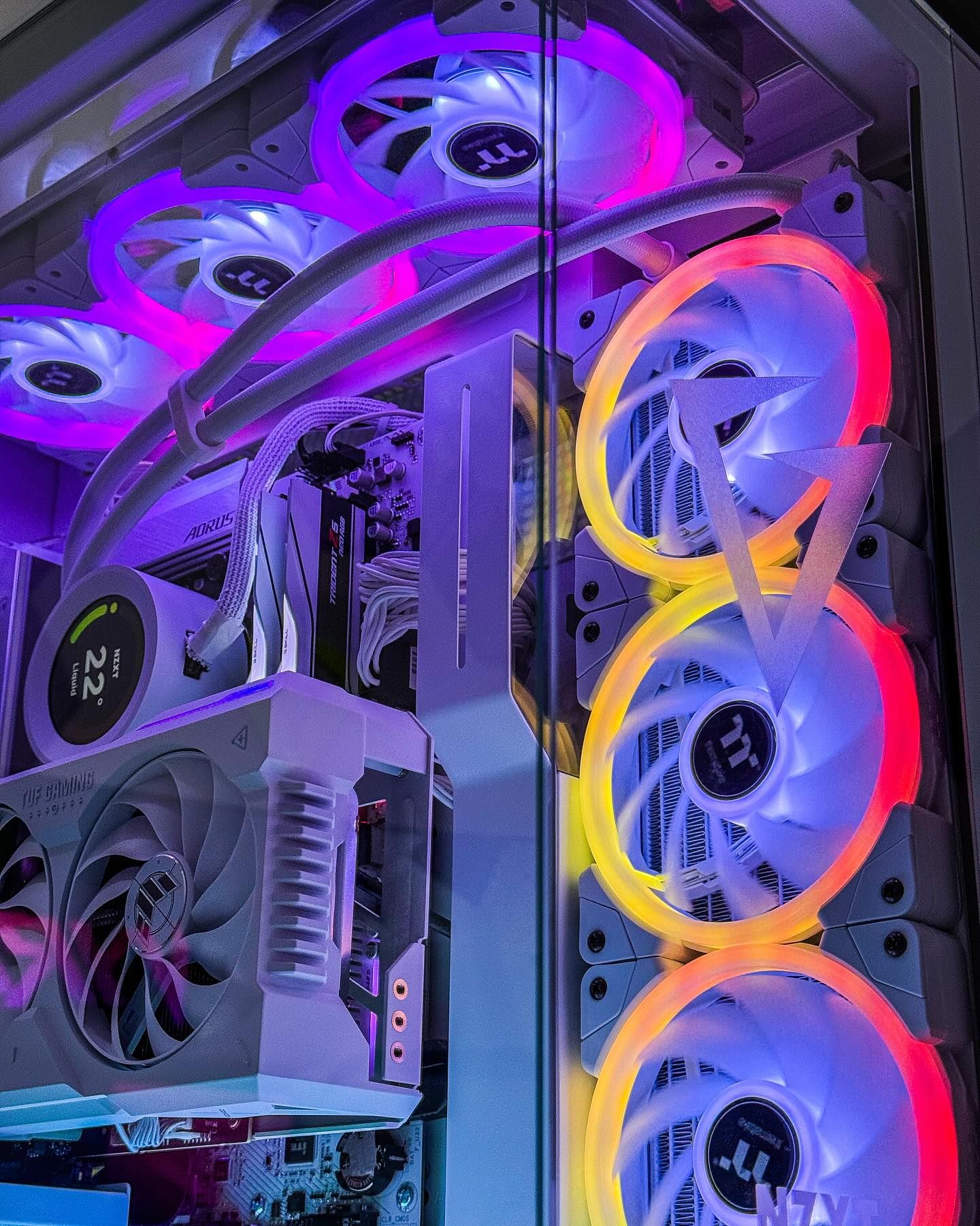 A gaming PC chassis interior showing graphics card fan lights and CPU cooling lines